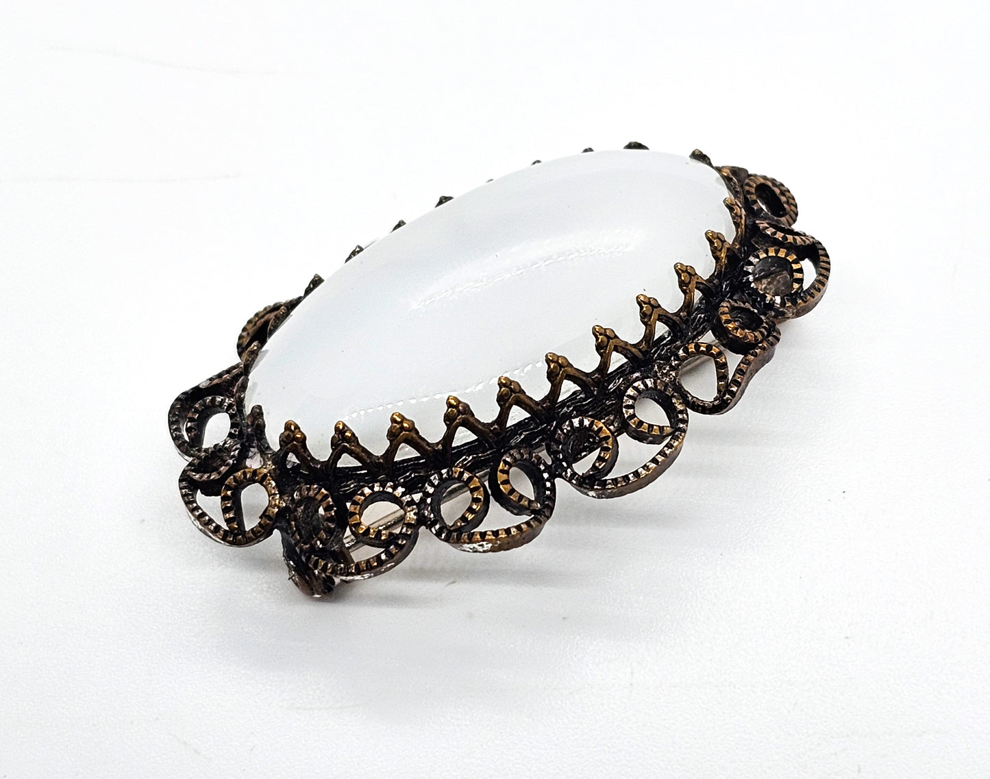 Austrian white Cat's Eye moonglow glass with filigree frame vintage brooch