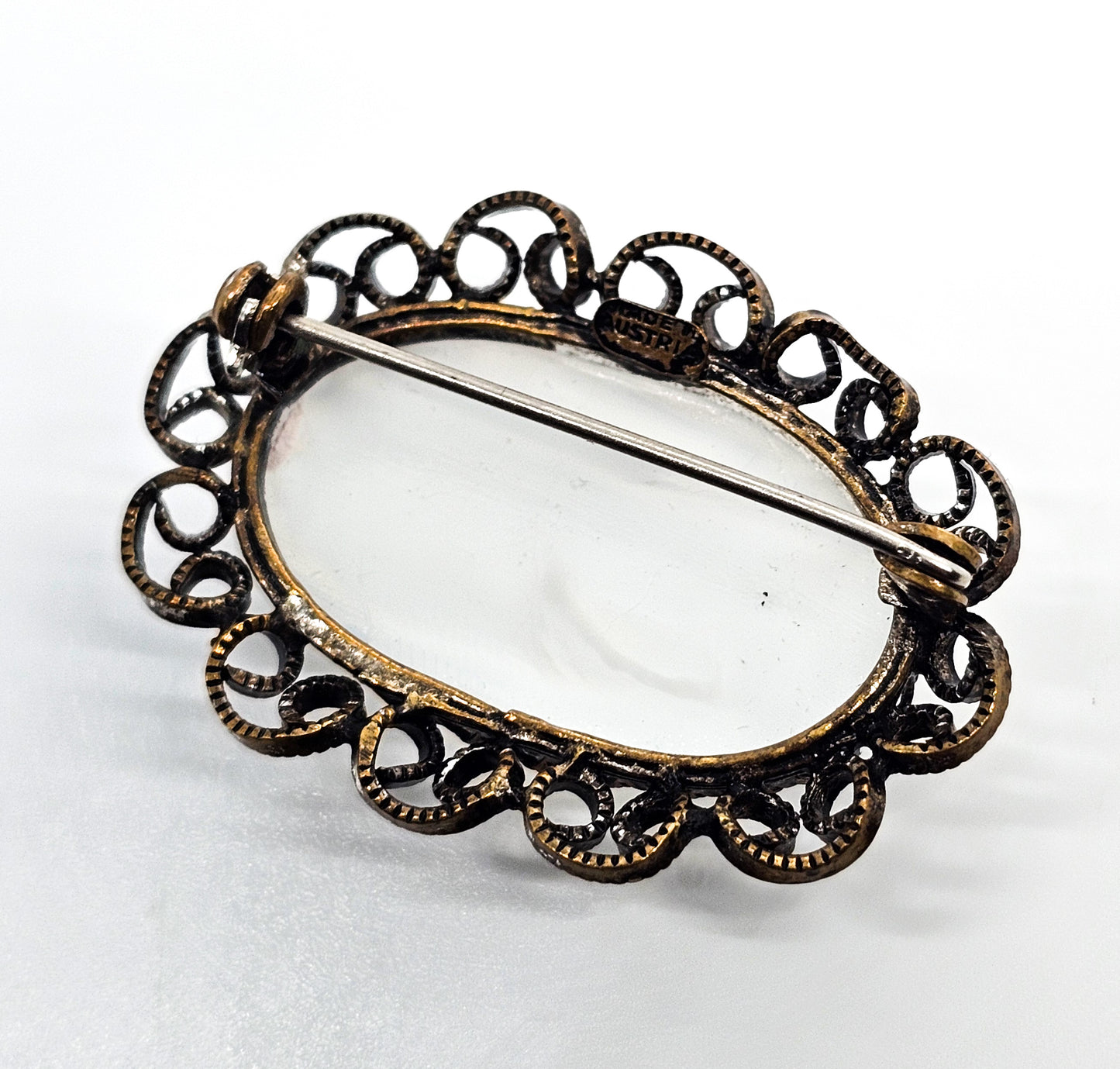 Austrian white Cat's Eye moonglow glass with filigree frame vintage brooch