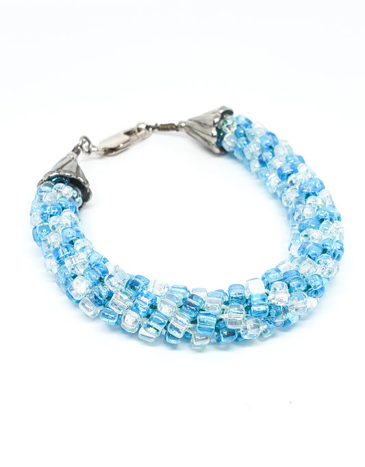 Oceans baby blue and clear torsade beaded bracelet with sterling silver clasp