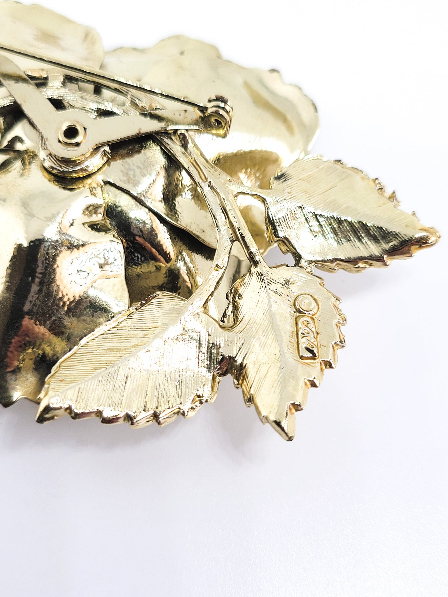 Coro signed Aurora borealis gold toned detailed signed flower brooch