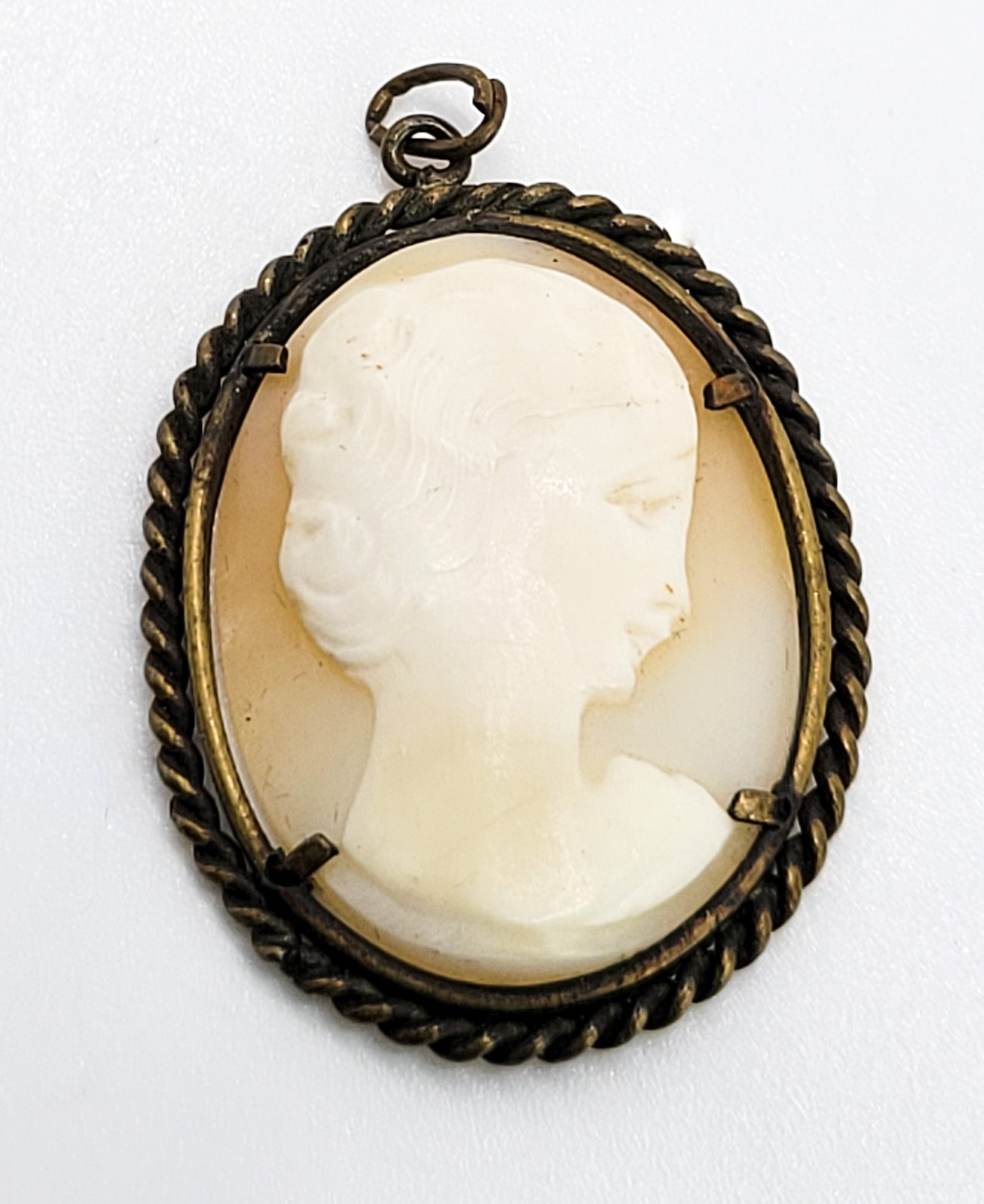 Carved shell right facing vintage woman cameo pendant in twisted rope brass setting
