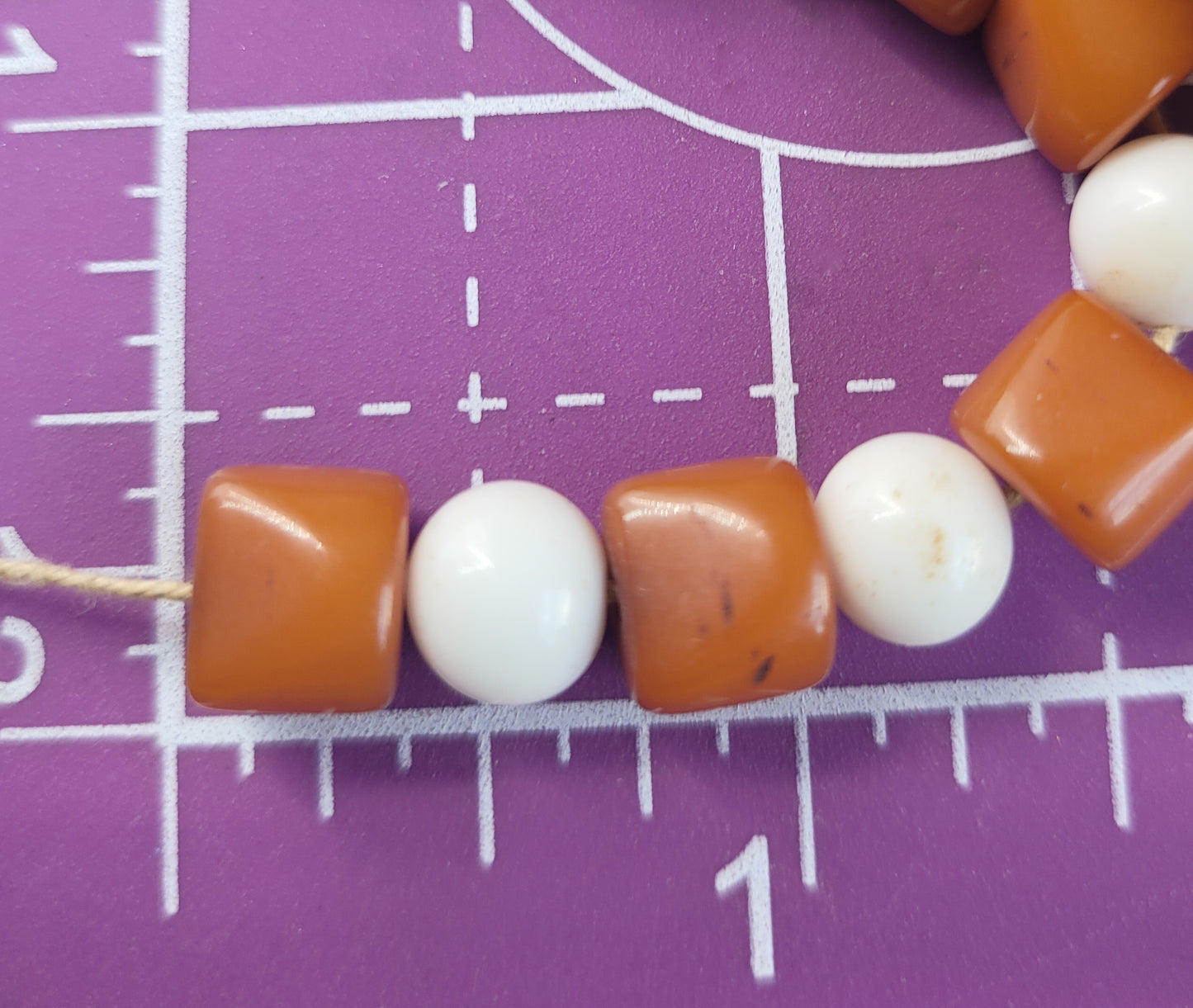 Amber bakelite and white milk glass strand of vintage beads on silk