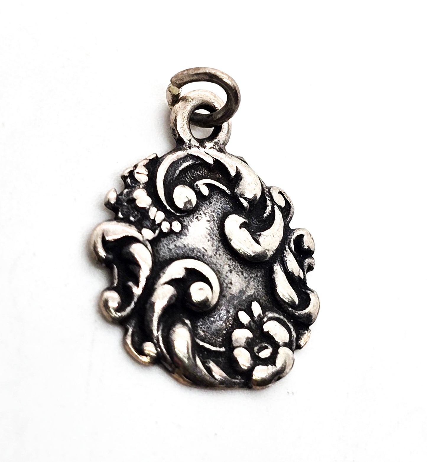 Antique Art Nouveau repousse sterling silver cartouche flower charm pendant