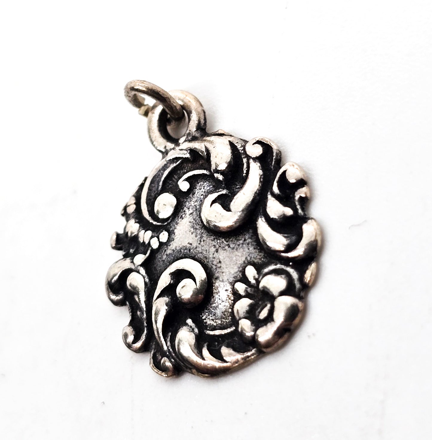 Antique Art Nouveau repousse sterling silver cartouche flower charm pendant