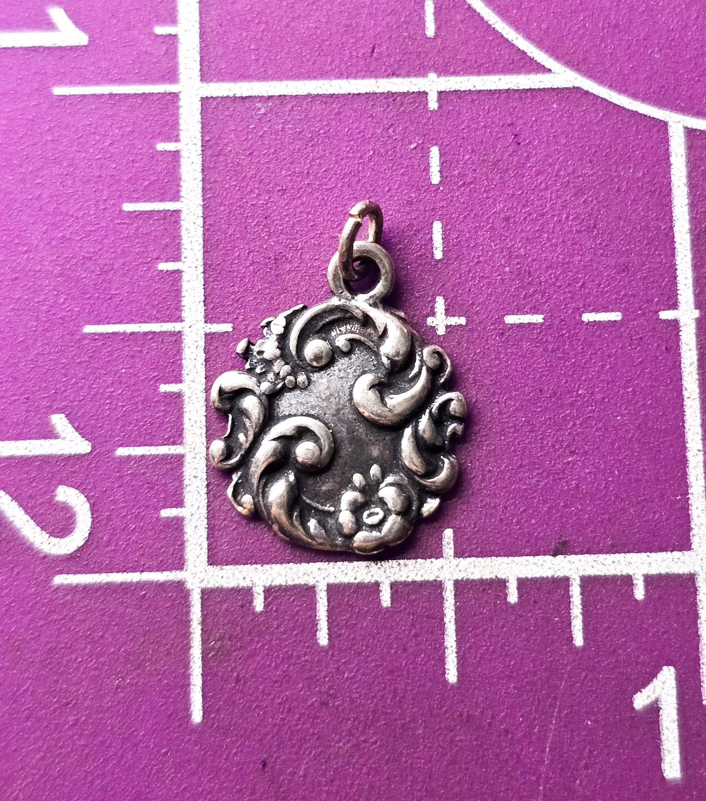 Antique Art Nouveau repousse sterling silver cartouche flower charm pendant