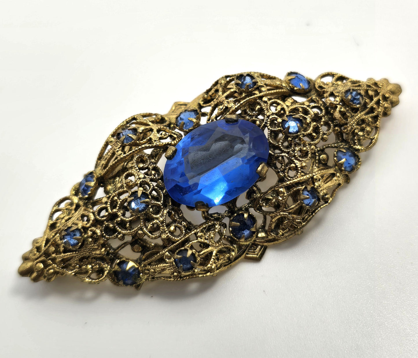 Czech bright blue paste glass rhinestone vintage gold toned filigree brooch