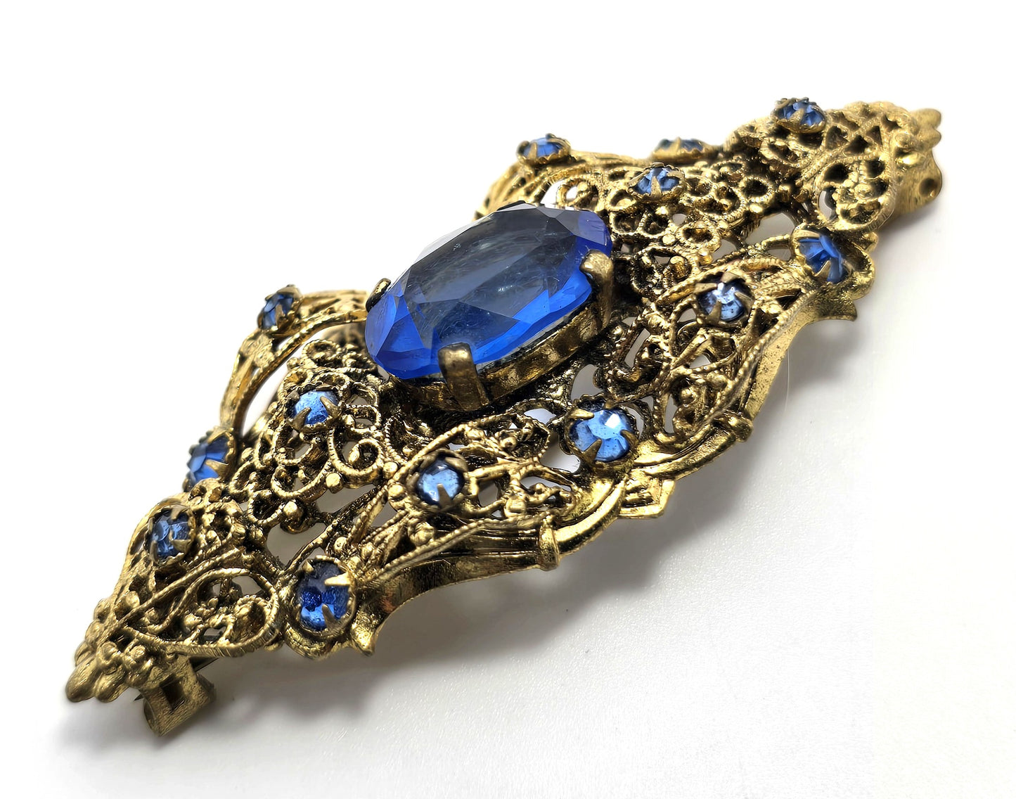 Czech bright blue paste glass rhinestone vintage gold toned filigree brooch