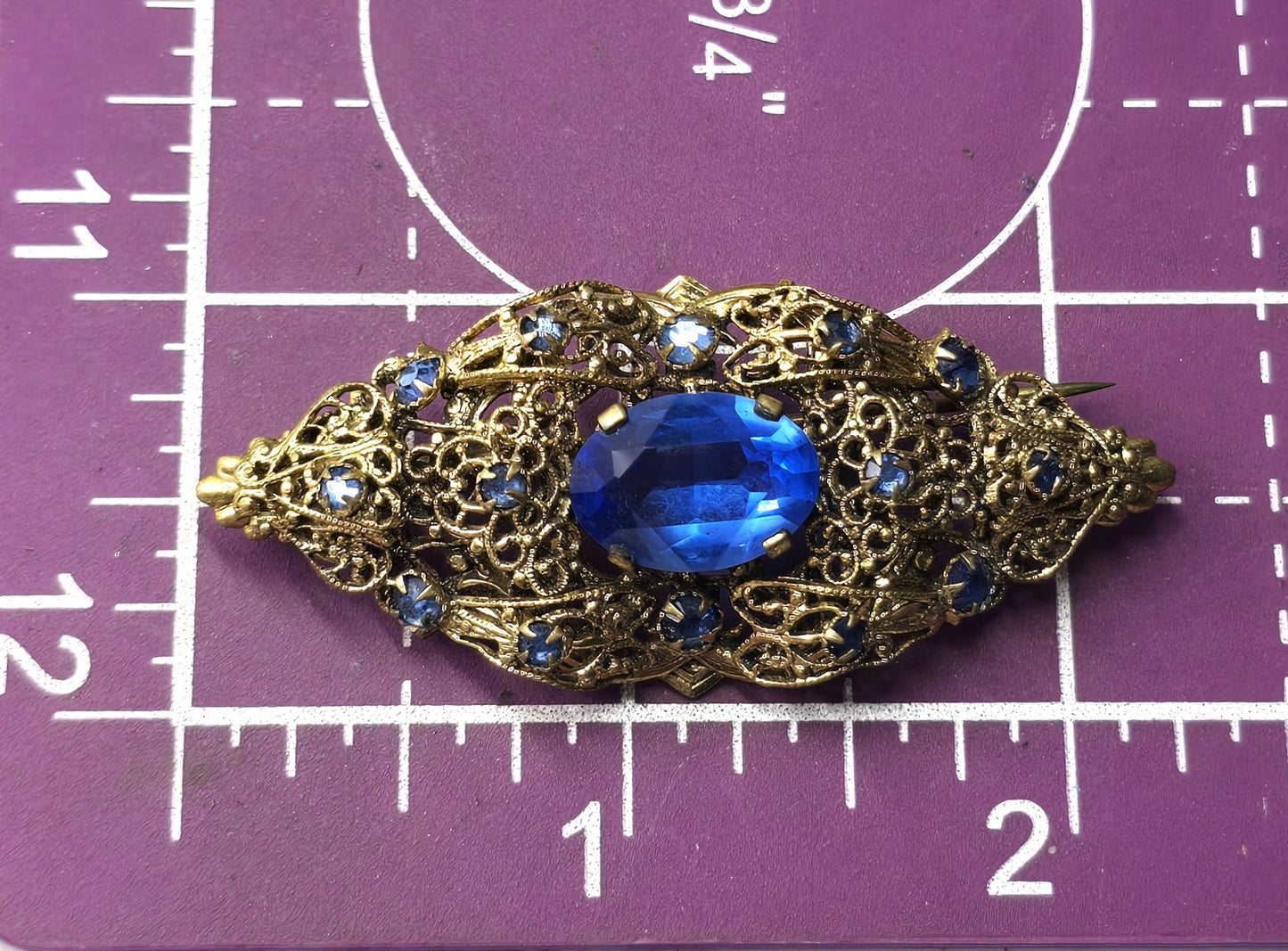Czech bright blue paste glass rhinestone vintage gold toned filigree brooch