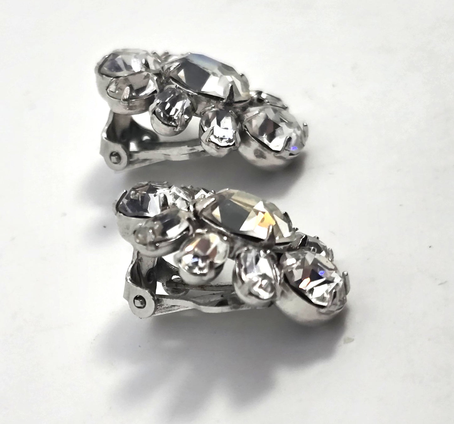 Bright vintage clear rhinestone silver toned cluster clip on earrings mid century