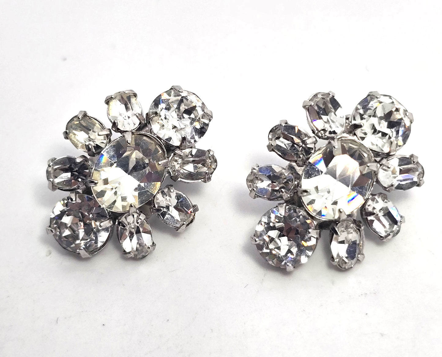 Bright vintage clear rhinestone silver toned cluster clip on earrings mid century