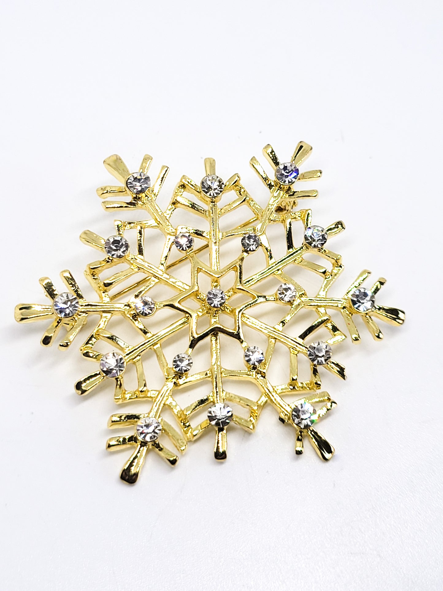 Snowflake gold toned clear rhinestone vintage Holiday winter pin brooch