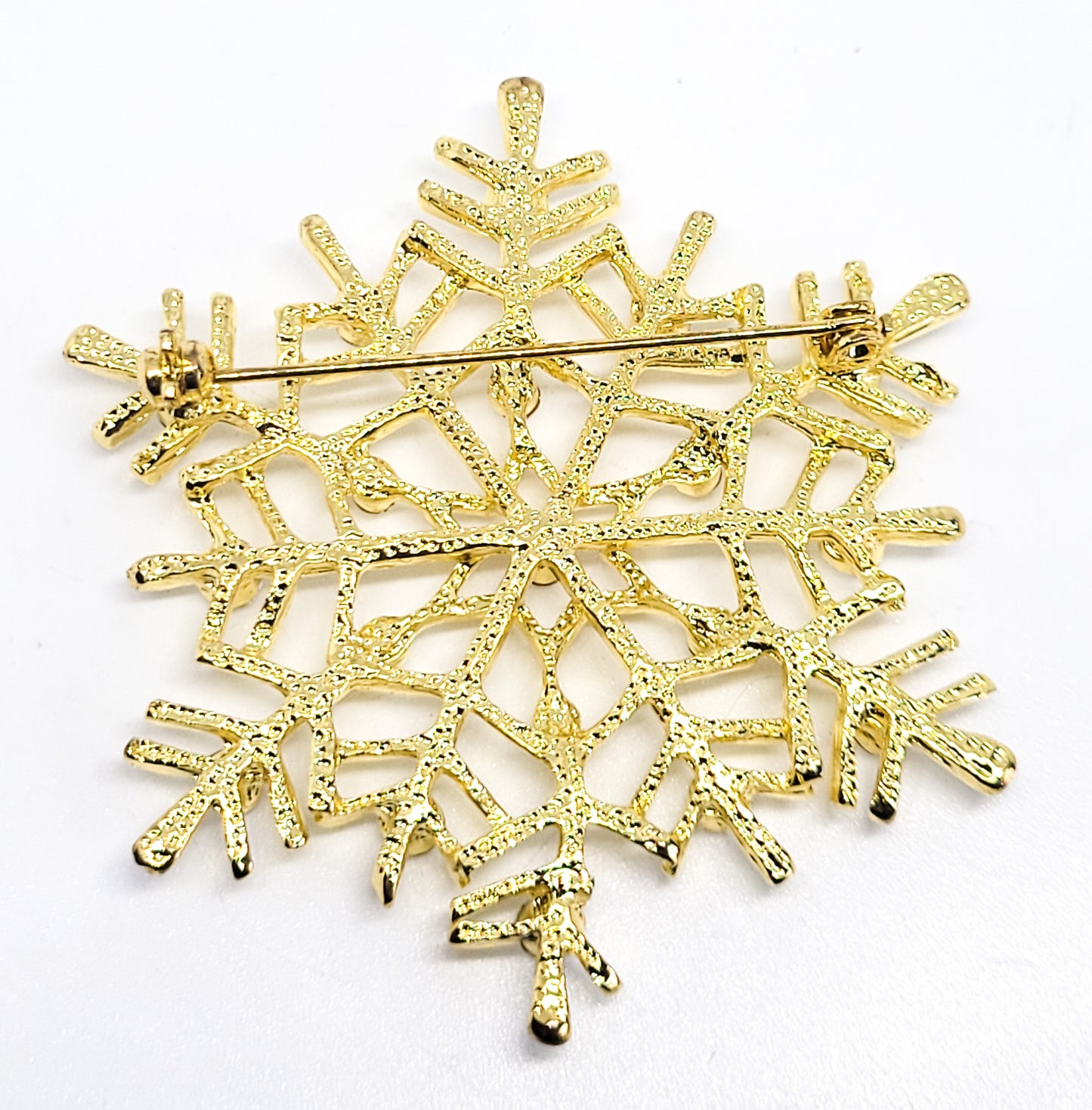 Snowflake gold toned clear rhinestone vintage Holiday winter pin brooch