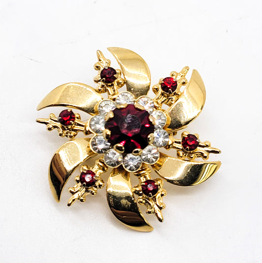 Ruby red and white gold toned vintage atomic snowflake brooch