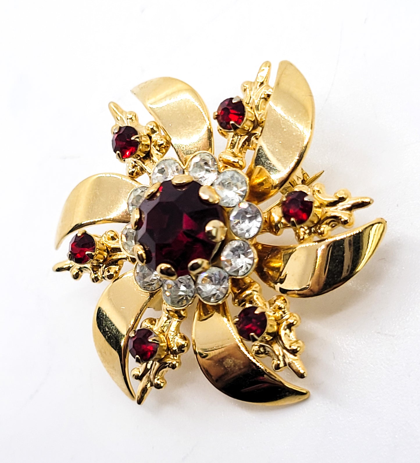 Ruby red and white gold toned vintage atomic snowflake brooch