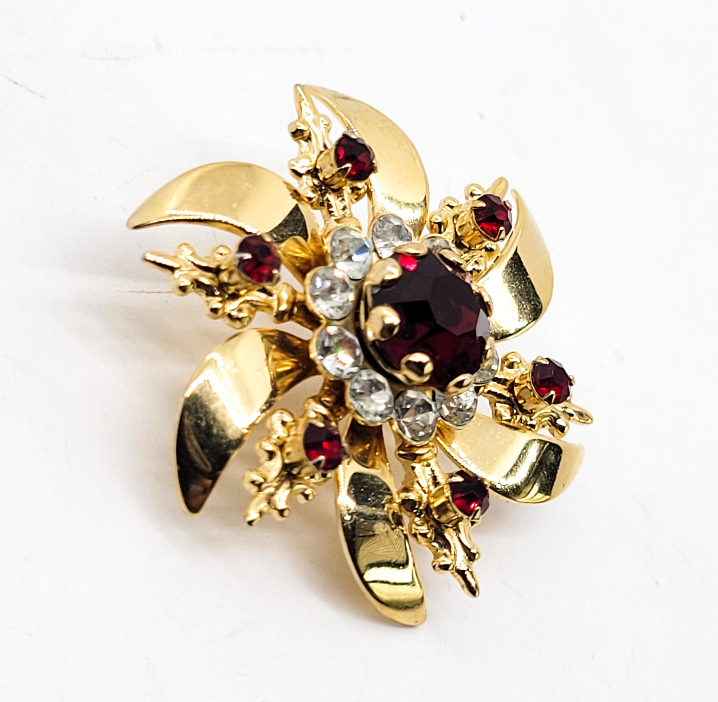 Ruby red and white gold toned vintage atomic snowflake brooch